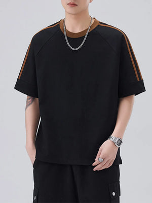 Black oversized t-shirt with brown contrast stitching on sleeves and neckline.