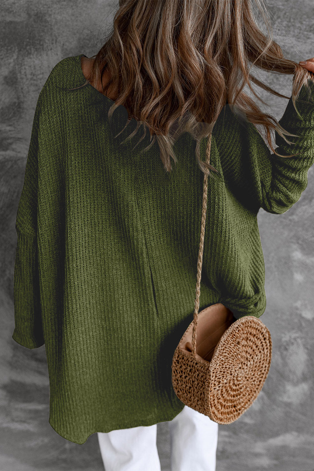 Moss green acrylic knit slouch top with asymmetric hem and relaxed fit.
