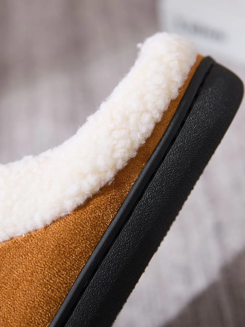 Caramel suede moccasin slides with cozy white shearling lining and black sole.