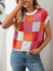 Checkerboard knit cap sleeve top in pink, orange, red, and white.