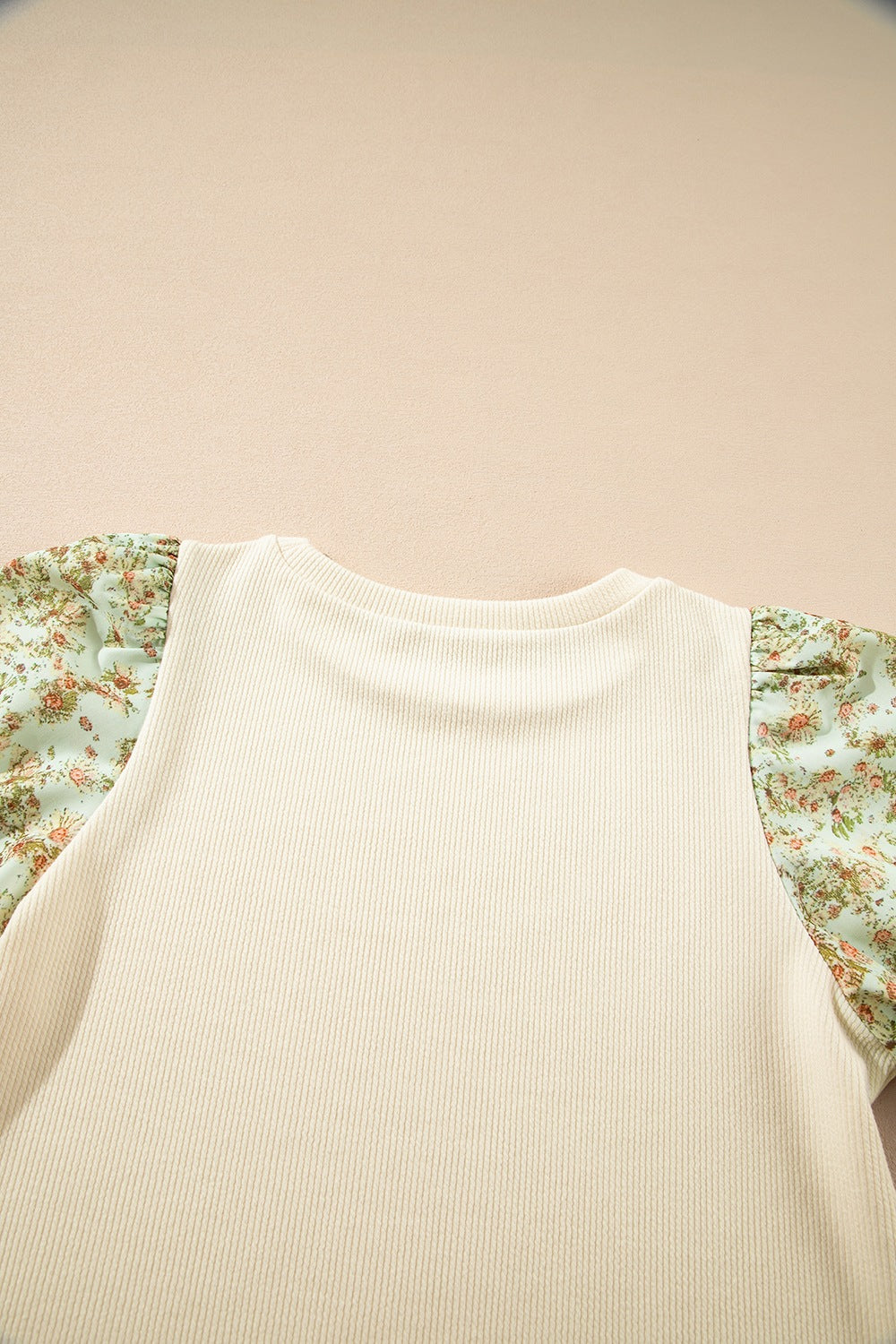 Beige ribbed knit top with floral puff sleeves and crew neck.