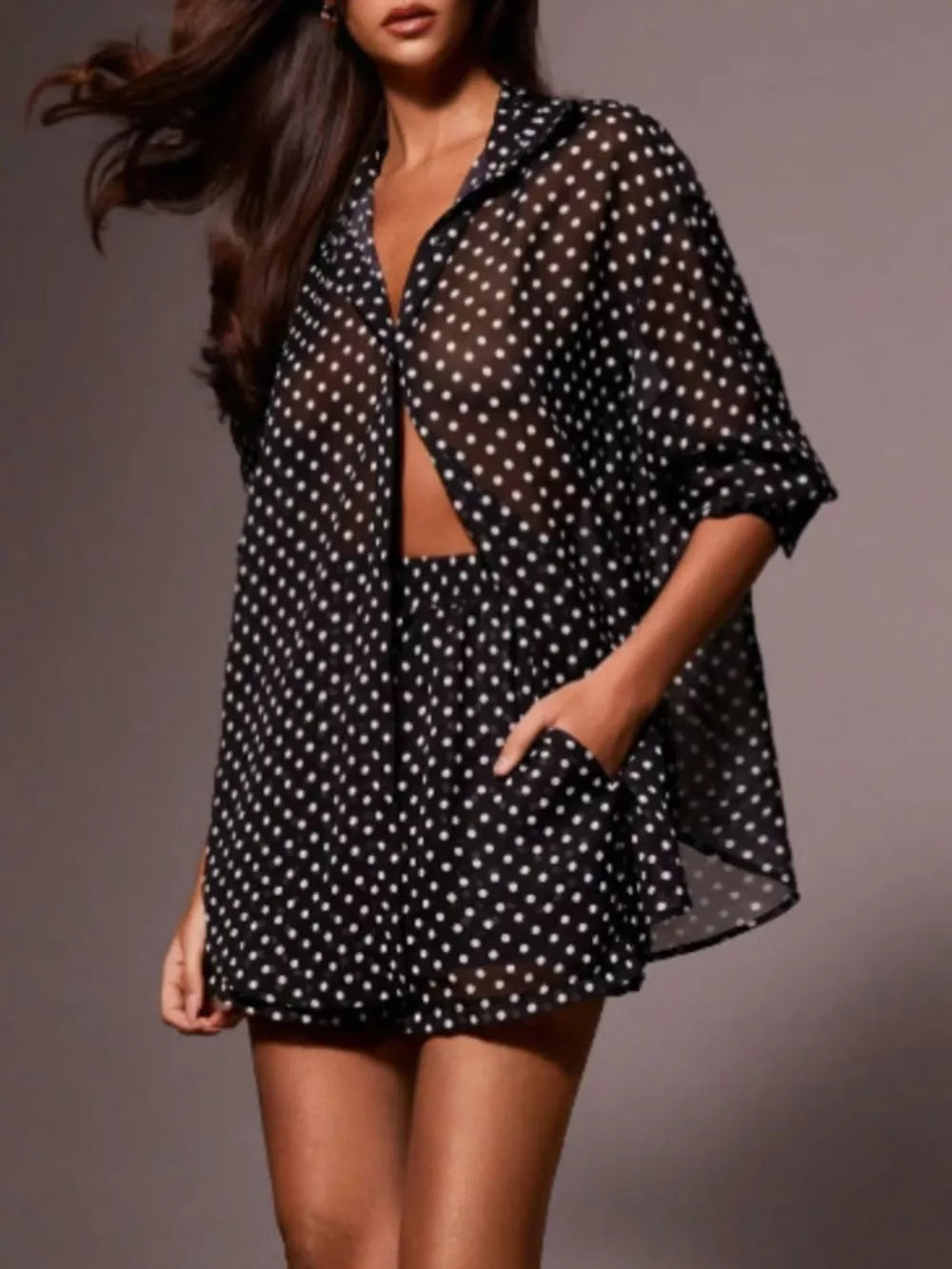 Black sheer polka dot two-piece set with button-up shirt and shorts.