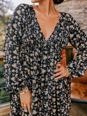 Floral babydoll dress with deep V neckline, smocked bodice, and bubble sleeves.