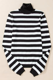 Graphic ribbed turtleneck sweater in black and white stripes.