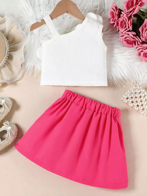 Baby girl's white ribbed tank with floral applique and pink pleated skirt.