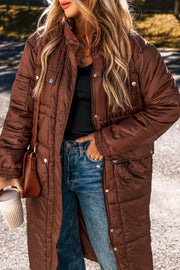 Brown quilted longline puffer coat with patch pockets and snap closures.