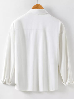 White cotton long sleeve button-up shirt with collar and rolled cuffs.