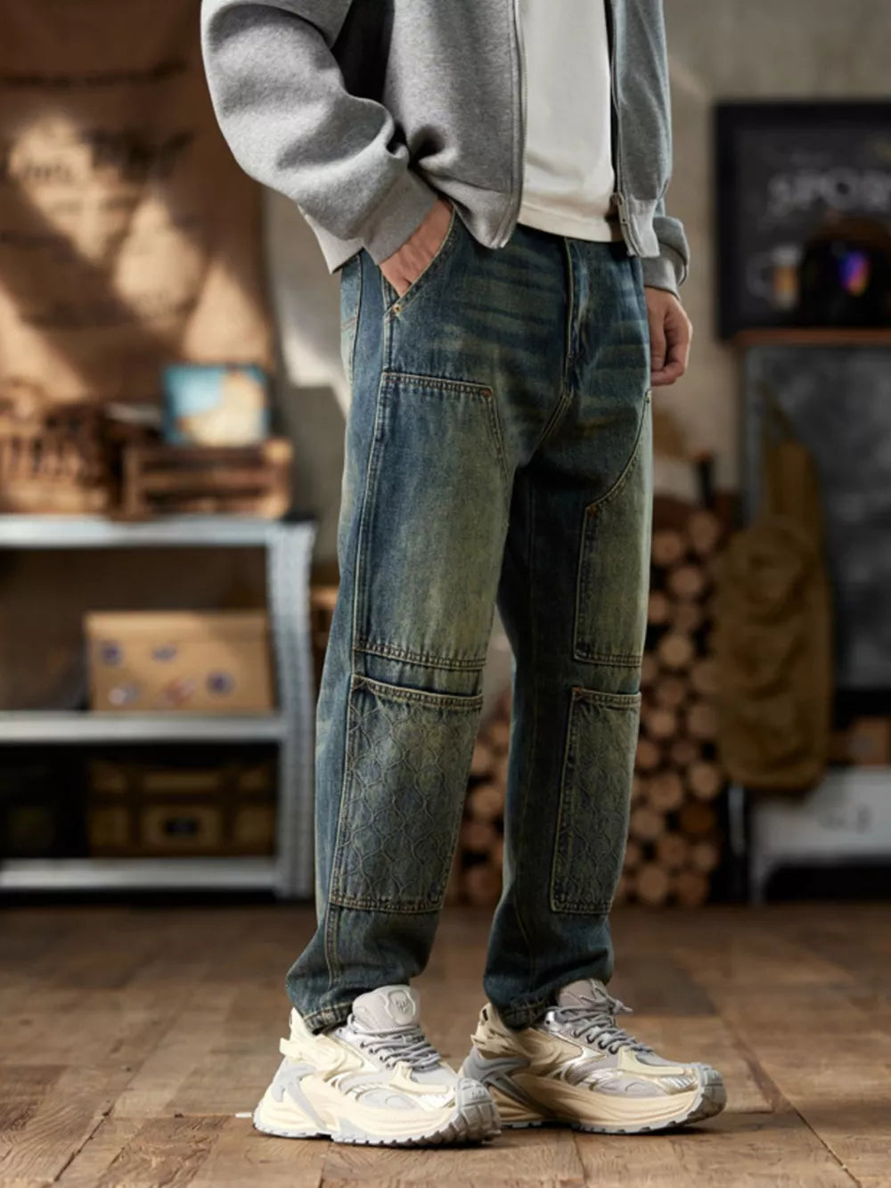 Men's blue cotton straight leg jeans with textured knee panels.