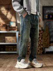 Men's blue cotton straight leg jeans with textured knee panels.