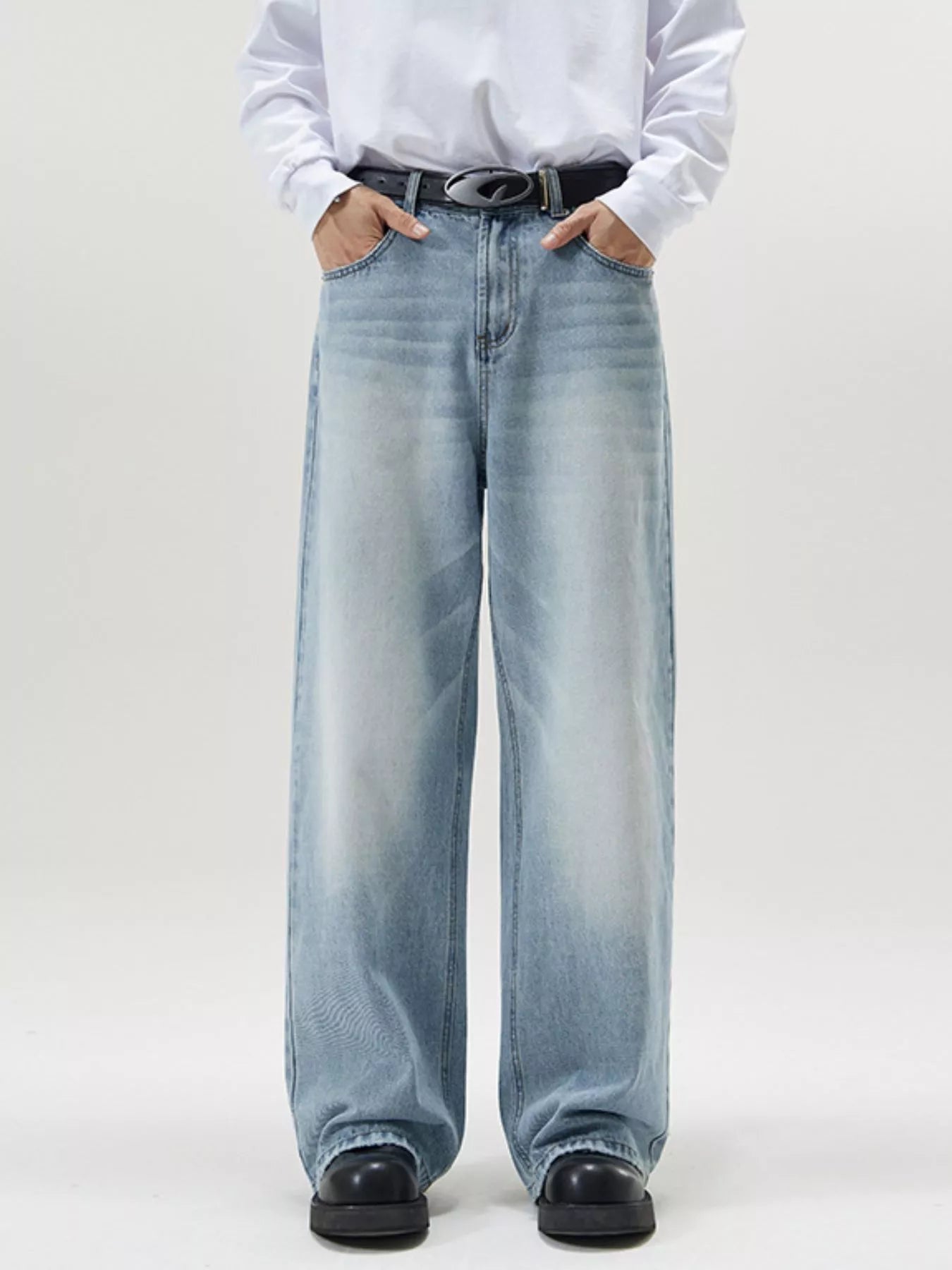 Men's wide-leg light blue wash denim jeans with a relaxed fit.