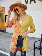 Colorblock leopard knit duster cardigan in acrylic with button front and pockets.