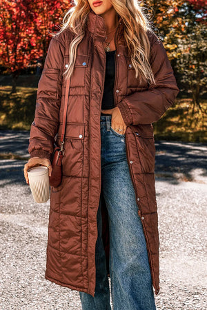 Brown quilted longline puffer coat with patch pockets and stand collar.