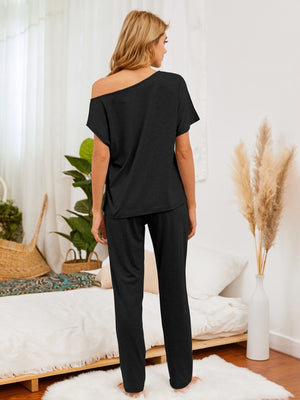 Black asymmetric shoulder lounge set with relaxed fit pants.