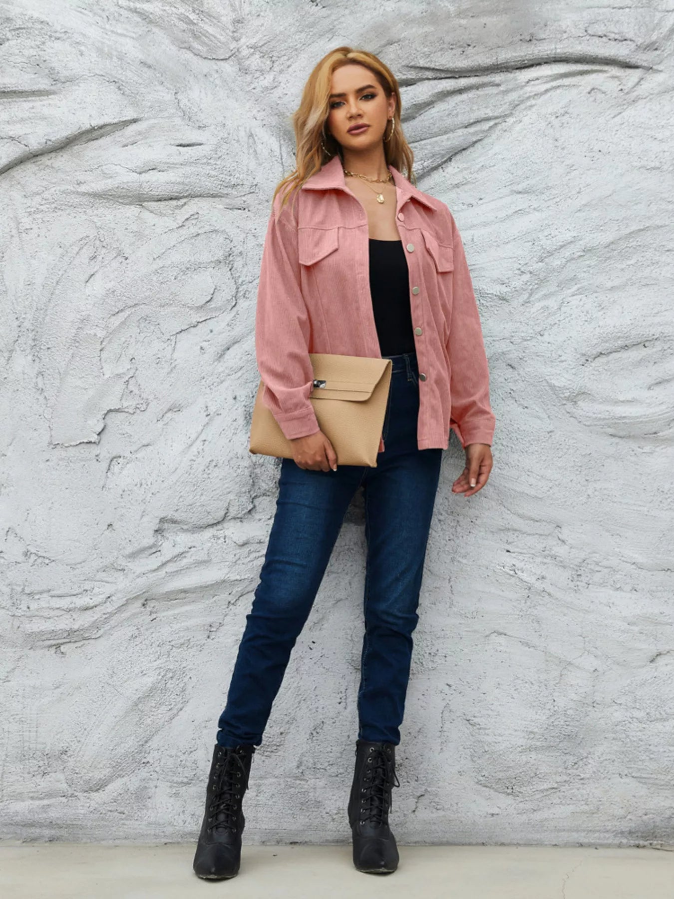 Pinkish corduroy button-up jacket with chest pockets and a collared neckline.