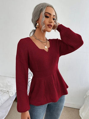 Wine peplum knit sweater with scallop neckline and long sleeves.