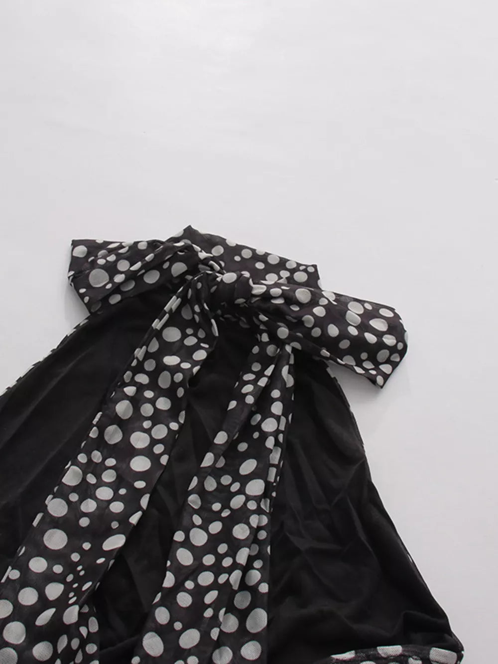 Chic polka dot halter maxi dress with a large bow detail.