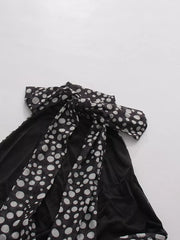 Chic polka dot halter maxi dress with a large bow detail.