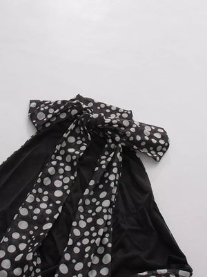 Chic polka dot halter maxi dress with a large bow detail.