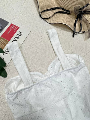White eyelet camisole with ruffled neckline and adjustable straps.