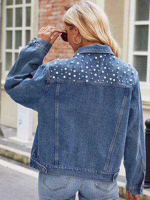 Denim jacket with pearl embellishments on the back yoke, buttoned front, medium wash.