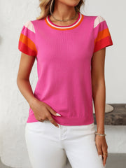 Colorblock knit top with flutter sleeves in hot pink, featuring striped neckline and sleeves.