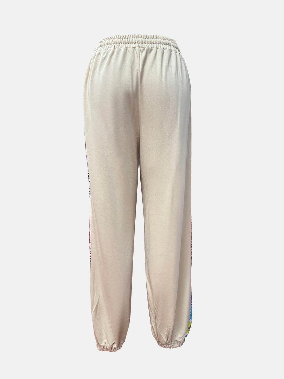 Tan jogger pants with embroidered stripe detail on the side seam.