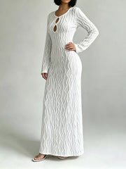 White long sleeve maxi dress with textured wavy pattern and keyhole cutout neckline.