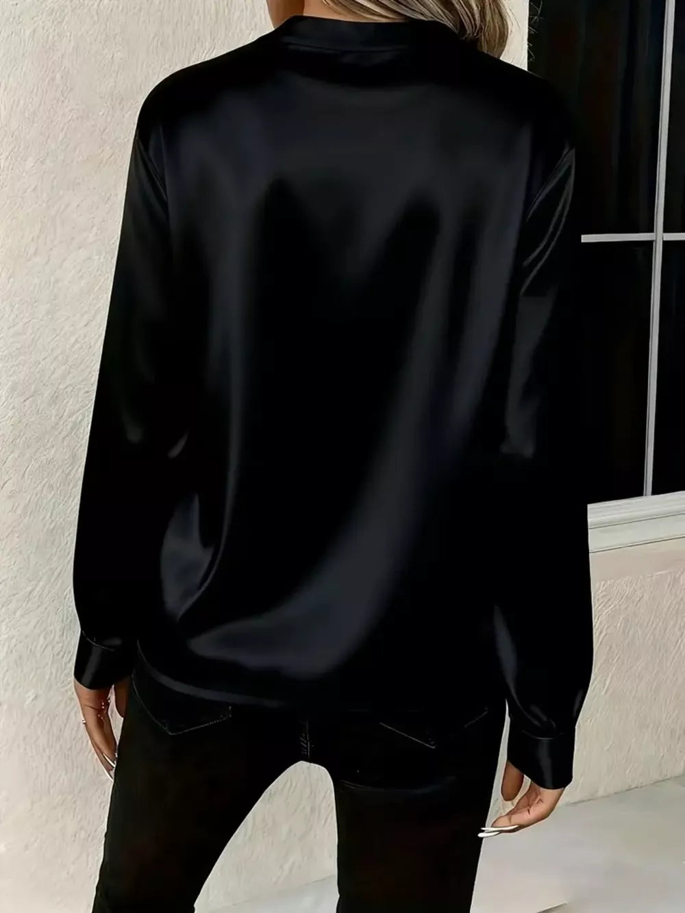 Black satin maternity blouse with buttoned cuffs and a notched V-neck.