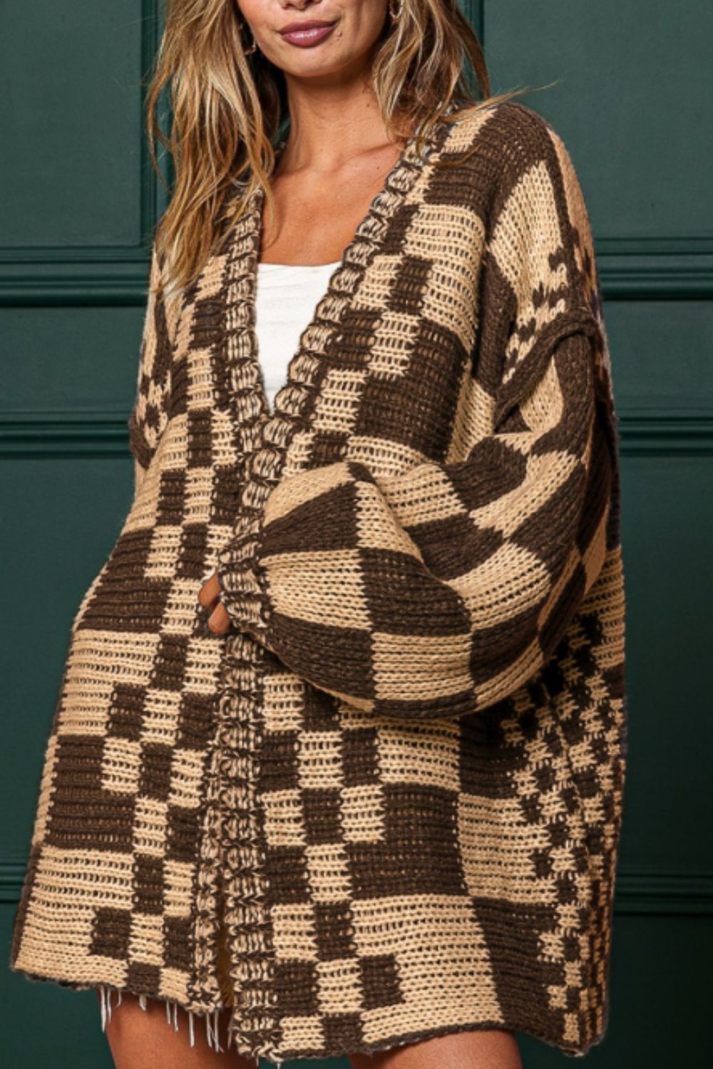 Tan and brown checkered acrylic cardigan with balloon sleeves and open front.