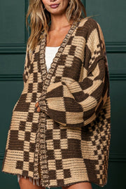 Tan and brown checkered acrylic cardigan with balloon sleeves and open front.