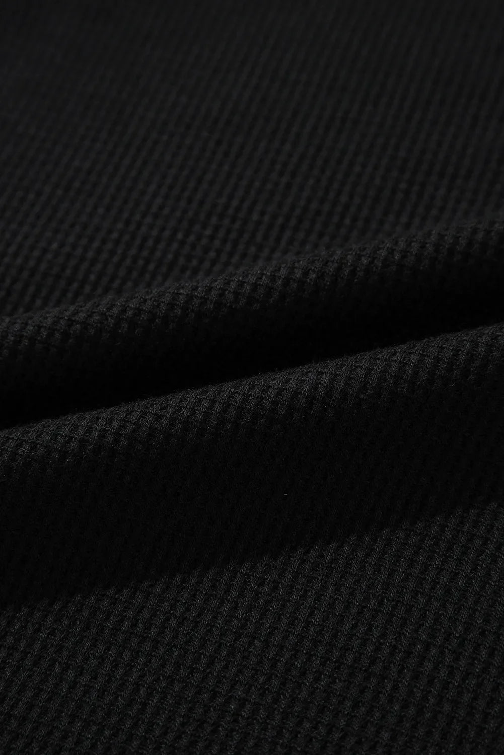 Black textured ribbed loungewear fabric detail