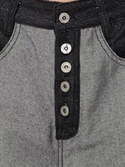 Men's grey and black cotton jeans with button fly and contrast stitching.
