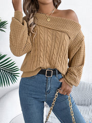 Camel off-shoulder cable knit pullover sweater with asymmetrical neckline and wide sleeves.