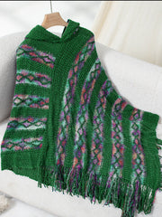 Dark green hooded knit cape with colorful diamond pattern and fringe detail