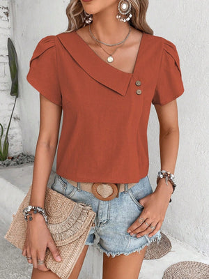 Terracotta asymmetric collar blouse with button detail and short puff sleeves.