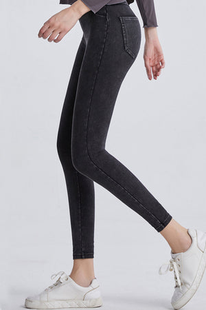 Dark gray denim leggings with faux pockets and a slim fit.