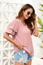 Dusty pink Swiss dot blouse with tiered short sleeves and a V-neck.