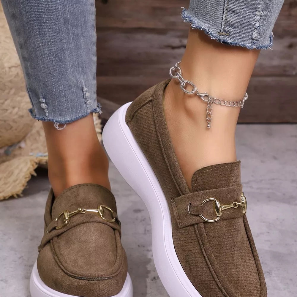 Brown loafers with gold horse-bit detail and white platform sole.