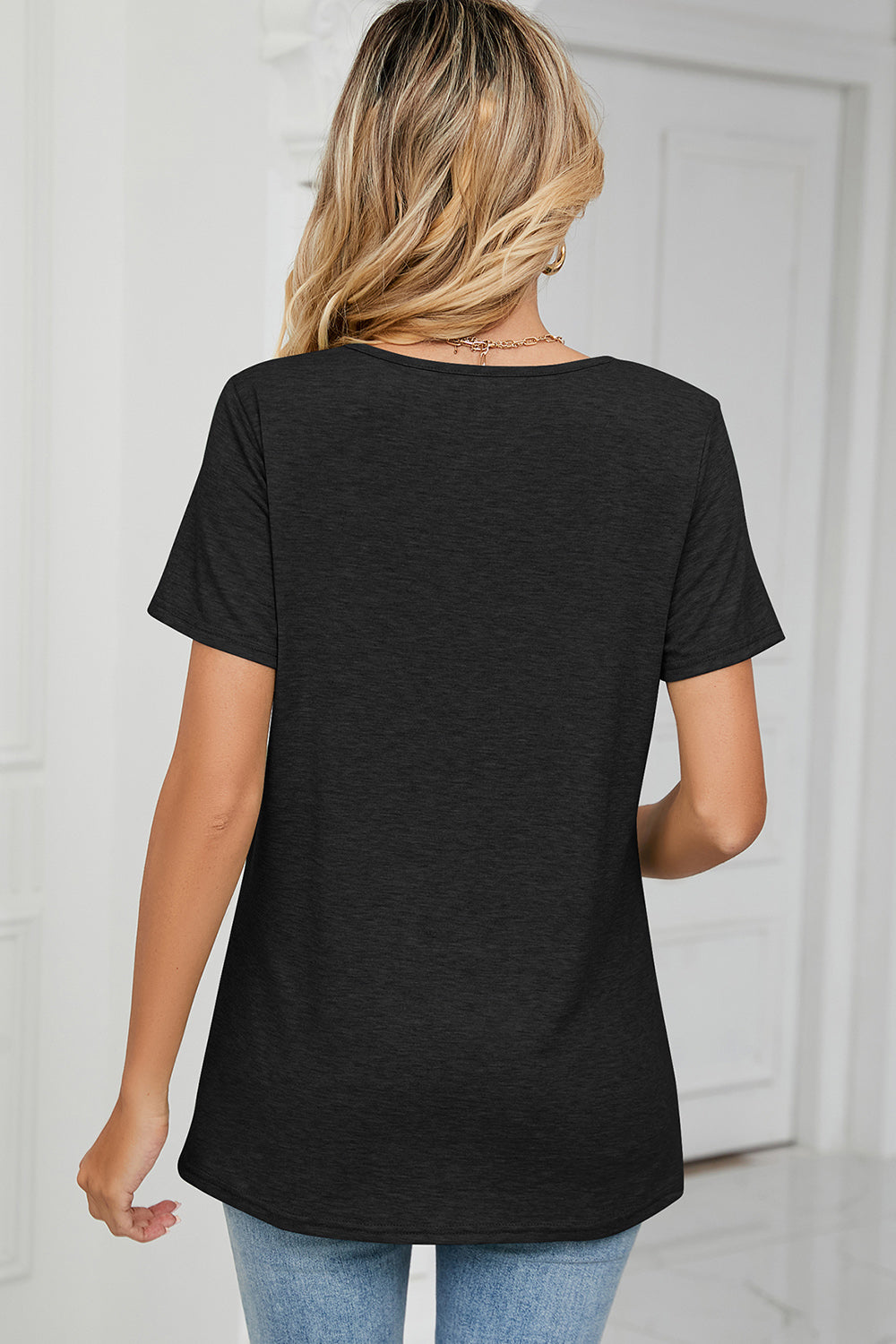 Black ruched v-neck jersey tee with short sleeves, shown from the back.