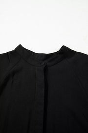 Black maternity maxi dress with mandarin collar and hidden placket detail.