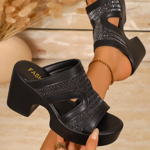 Black open-toe block heel sandals with glitter detail and cut-outs.