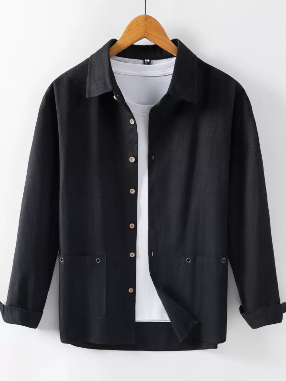 Black long sleeve button-up shirt with two chest pockets, worn over a white tee.