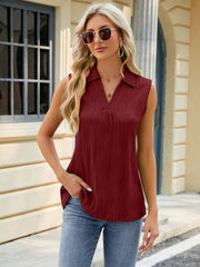 Burgundy textured collared sleeveless blouse with a V-neck and subtle pleating.