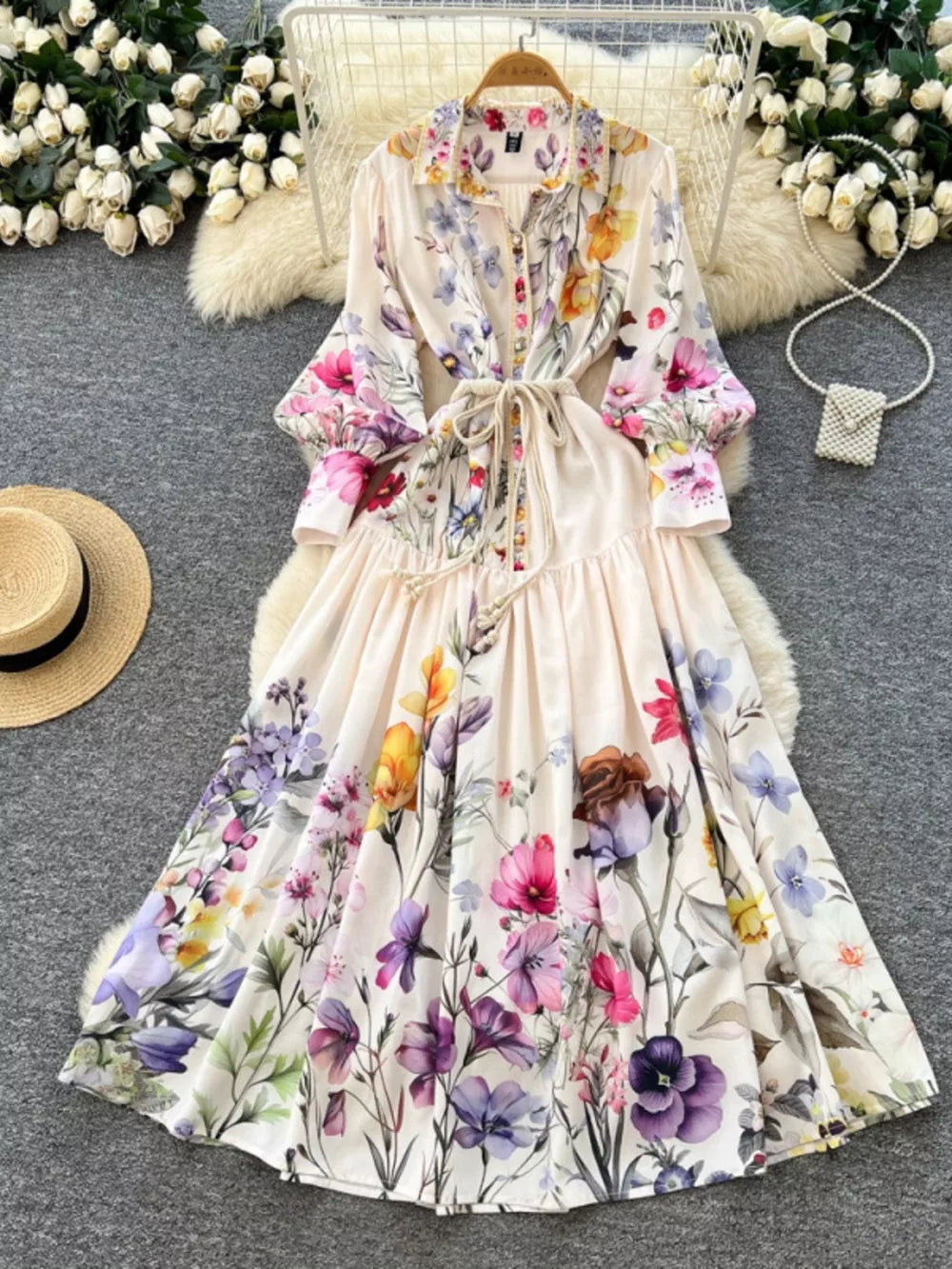 Vibrant floral midi dress with lantern sleeves, button front, and tie waist.