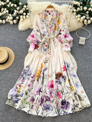 Vibrant floral midi dress with lantern sleeves, button front, and tie waist.