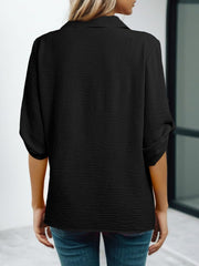 Black crinkled texture shirt with Johnny collar and cuffed short sleeves.