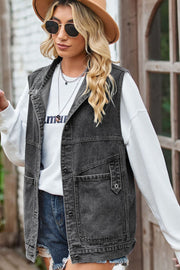 Dark denim vest with buttoned pockets and collar, worn over a white sweatshirt.