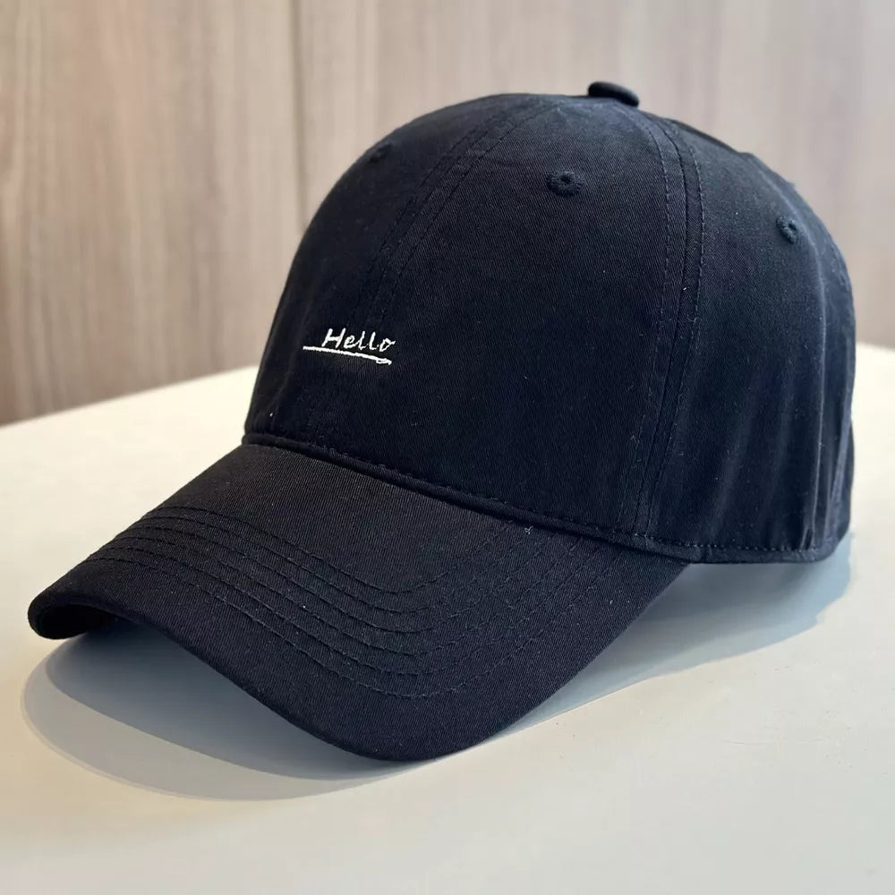 Black baseball cap with embroidered "Hello" detail