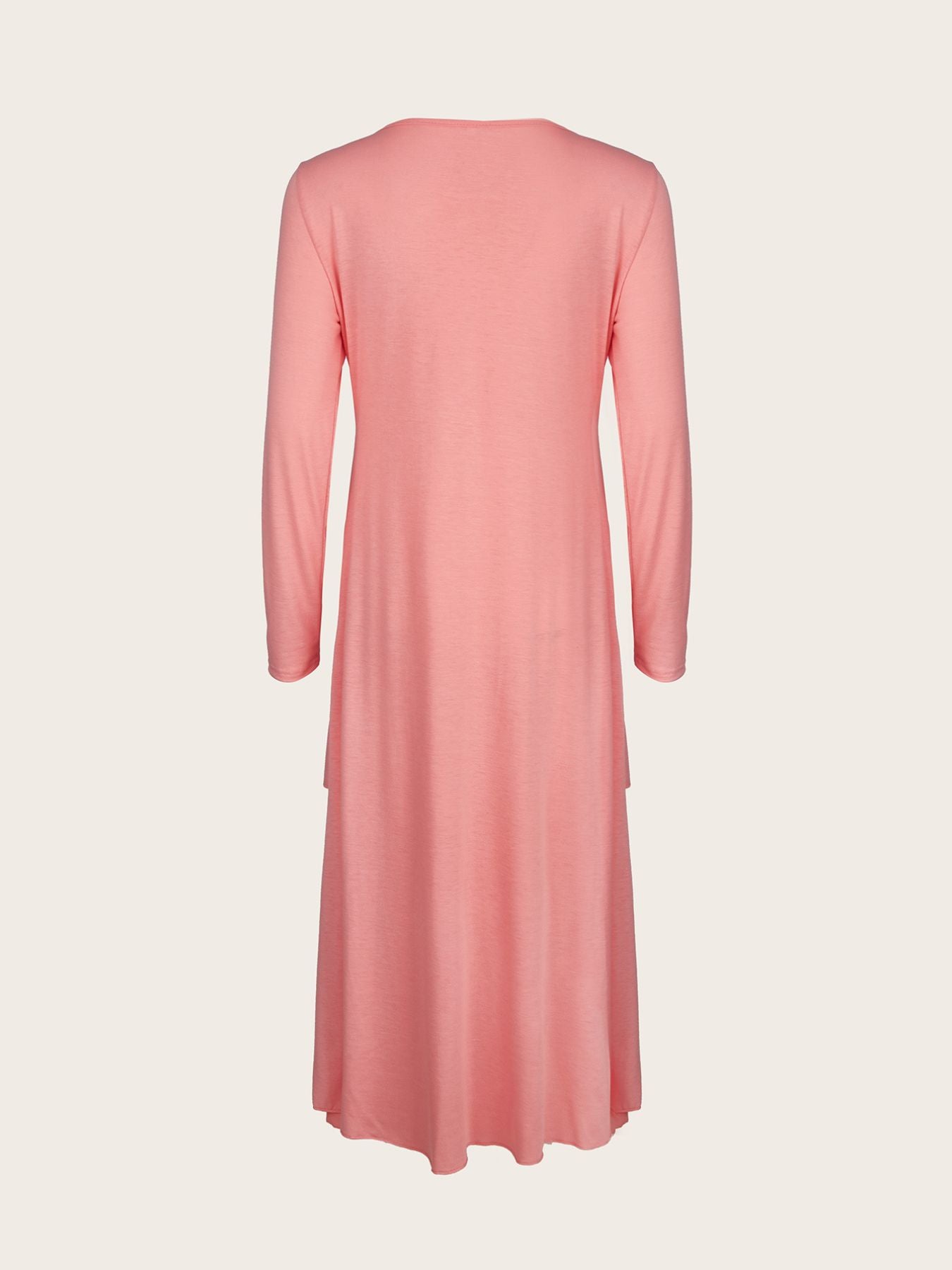 Pink midi dress with long sleeves and tiered hem detail.