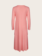 Pink midi dress with long sleeves and tiered hem detail.